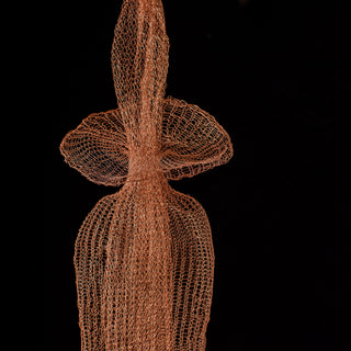 Artistic representation of a human figure made from interwoven copper wire on a black background