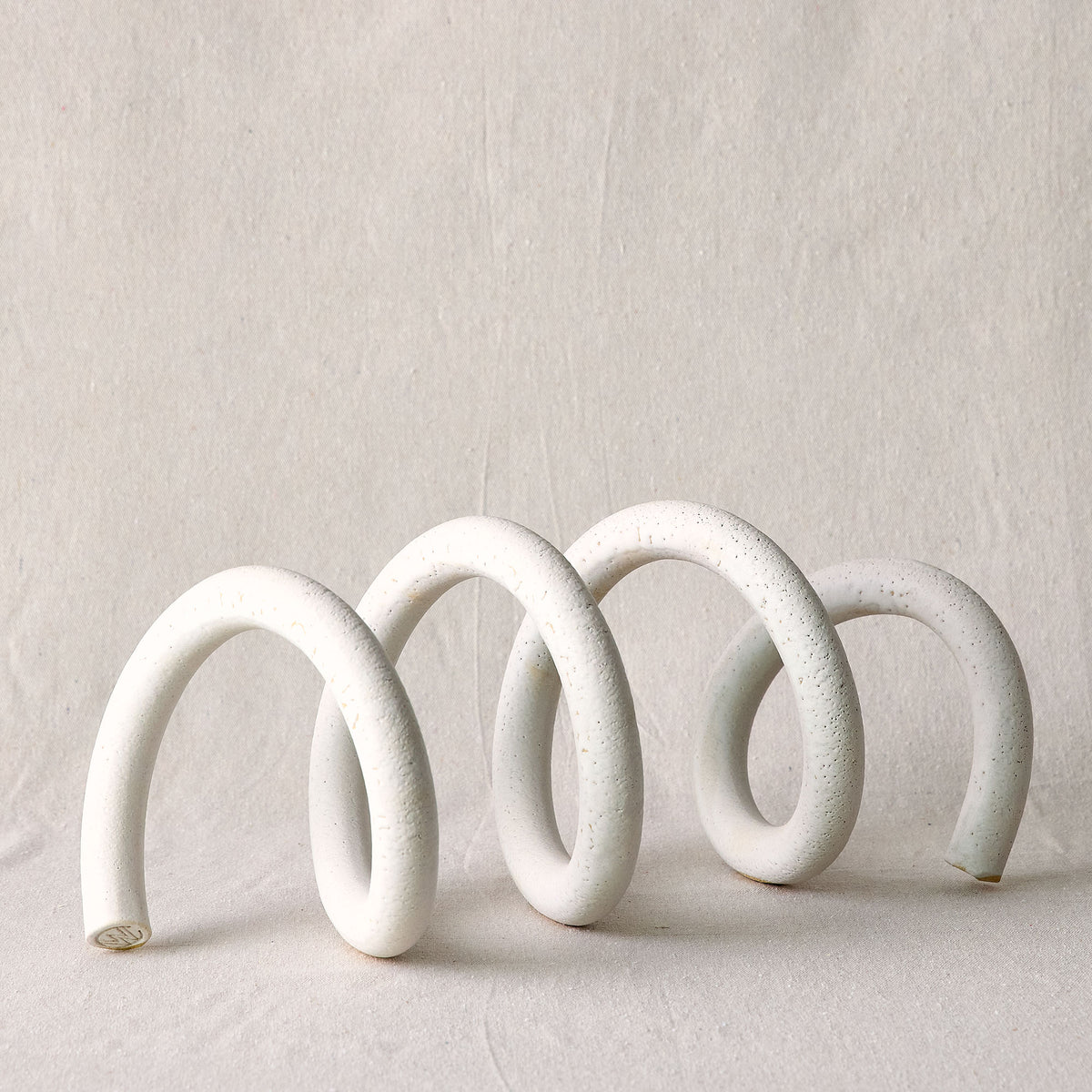 A white ceramic spiral sculpture