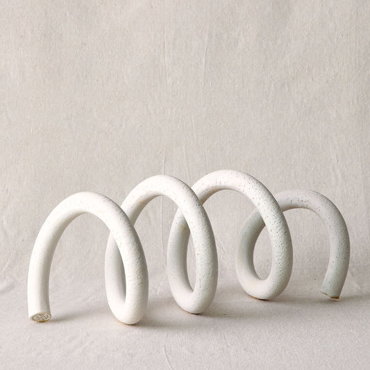 A white ceramic spiral sculpture