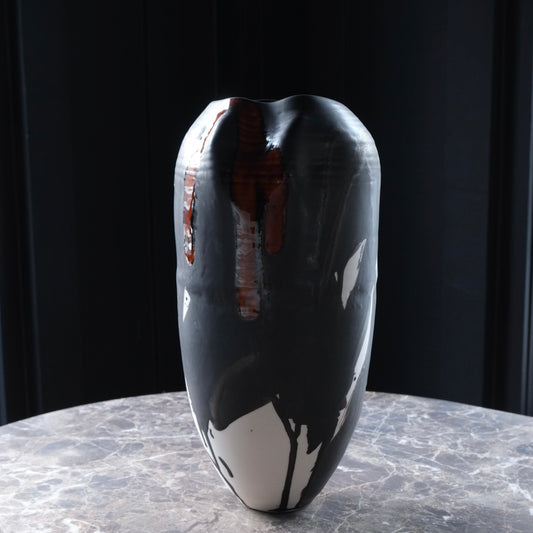 Black and white abstract vase on a dark background