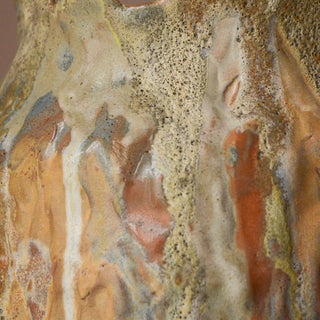 Close-up of a textured ceramic surface with earthy tones