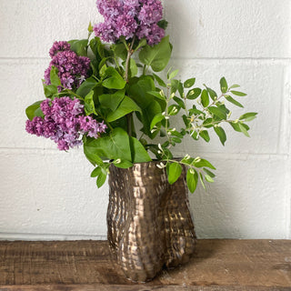 Bouquet of purple flowers in a textured bronze vase by Sarah Mijares Fick