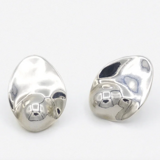 Pair of Sterling Silver earrings on a white background by Luz Ortiz New York