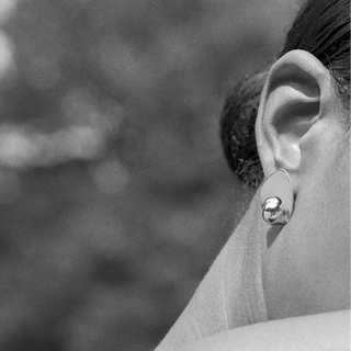 Close-up of an ear wearing a sterling silver earring  by Luz Ortiz New York