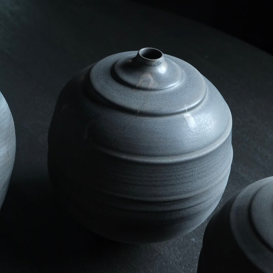 Black ceramic vase on a dark background